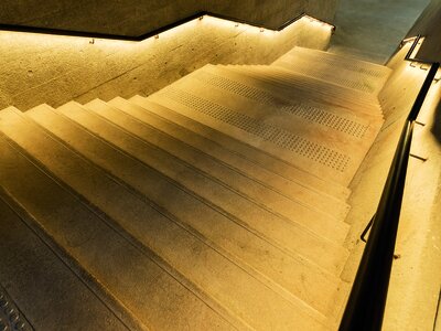 1436054538 illuminated old stairway in the dark